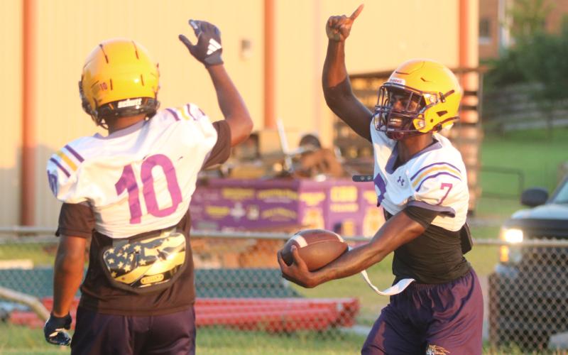 Columbia receiver Kyren Caldwell (right) celebrates with receiver Antonio Days after scoring a touchdown on a long catch-and-run during Monday’s practice. (JORDAN KROEGER/Lake City Reporter)
