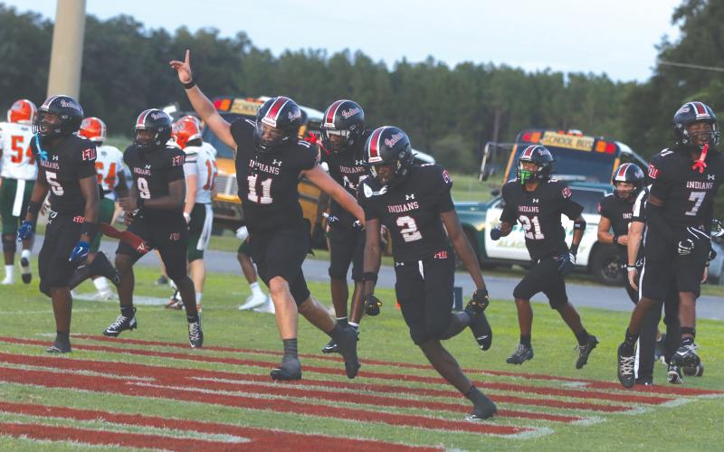 Fort White safety Marvion Wallace (2) celebrates with his teammates after his first interception return for a touchdown against Eastside on Friday. (MORGAN MCMULLEN/Lake City Reporter)