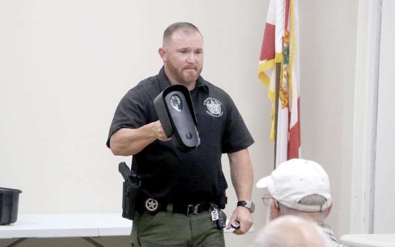 Suwannee County Sheriff’s Office Investigator Jacob Williamson shows nearly 30 people at the Suwannee River Regional Library’s Live Oak branch a Flock camera during Monday’s community meeting. (MORGAN MCMULLEN/Lake City Reporter)