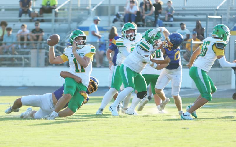 Suwannee quarterback Haigen Johnson throws as he’s being tackled from behind Friday night. Johnson connected with Kamari Lovett for a 66-yard touchdown on the play. (PAUL BUCHANAN/Lake City Reporter)