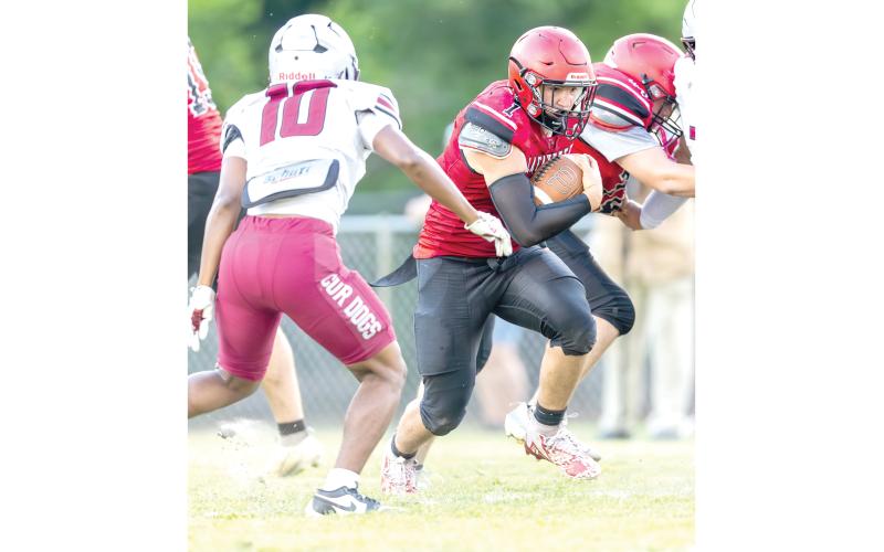 Lafayette running back Trevor Byrd powers ahead against Madison County in the teams’ spring game. (JACK HOWDESHELL/Lake City Reporter)