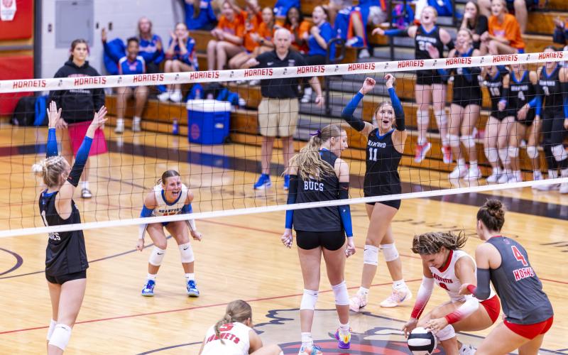 Branford middle blocker Raelea Bradow (6) looks back as her block of Lafayette hitter Sophia Kendrick's (8) attack hits the court Thursday night. (JACK HOWDESHELL/Lake City Reporter)