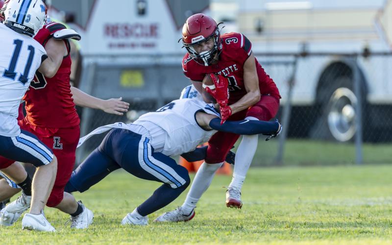 Lafayette receiver Lane O’Steen (3) reacts to the hit by a Maclay defensive back on Friday. (JACK HOWDESHELL/Lake City Reporter)