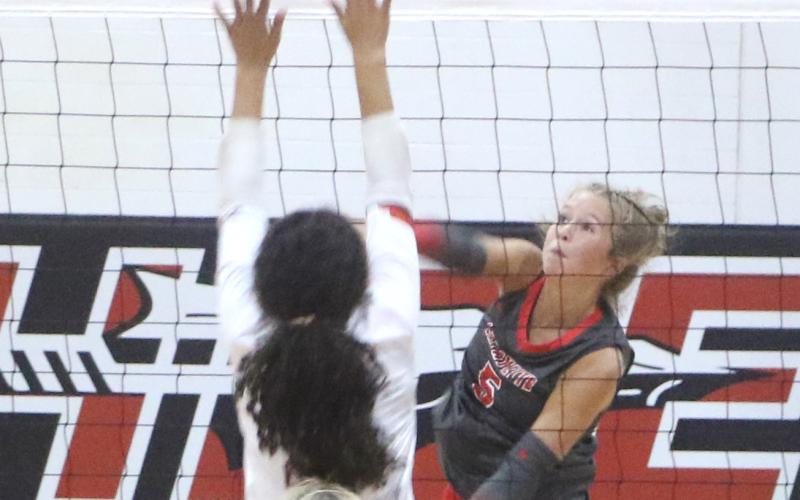 Lafayette setter Havyn Richardson (5) fires a shot over the block of Fort White's Shaylee Lindsey during the Hornets' 3-1 win over the Indians. (MORGAN MCMULLEN/Lake City Reporter)