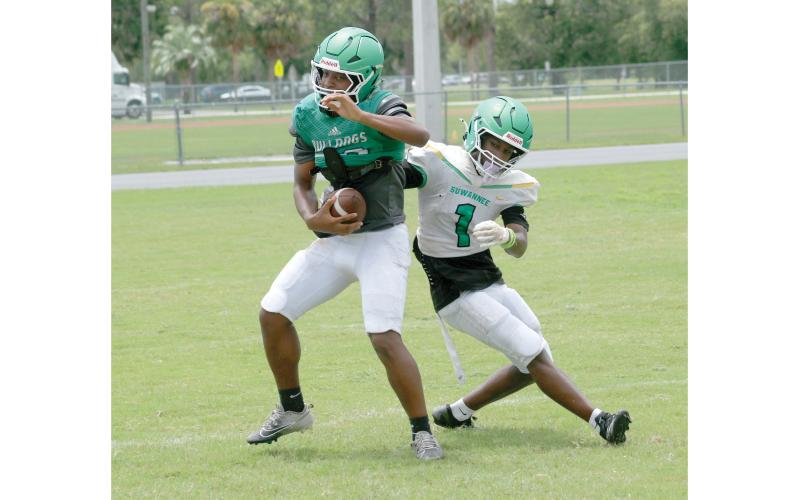 Suwannee safety Josh Johnson intercepts a pass in front of receiver Jamarcus Cherry during practice on Aug. 3. (JAMIE WACHTER/Lake City Reporter)