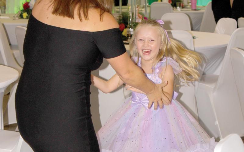 A child laughs while dancing at the inaugural Laced Up for Love Sneaker Ball last year. (COURTESY)