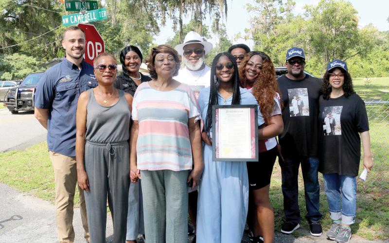 Lake City Mayor Noah Walker (far left) stands with council member Tammy Harris and members of the Layne and Foreman families after renamed streets dedicated to the families were unveiled on Tuesday morning. (TONY BRITT/Lake City Reporter)