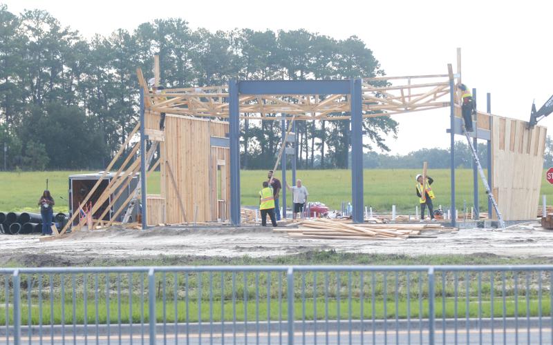 A construction crew works on rebuilding the frame to a new Zaxby’s restaurant Friday morning at Cornerstone Crossing. It’s set to open Nov. 16. (JAMIE WACHTER/Lake City Reporter)