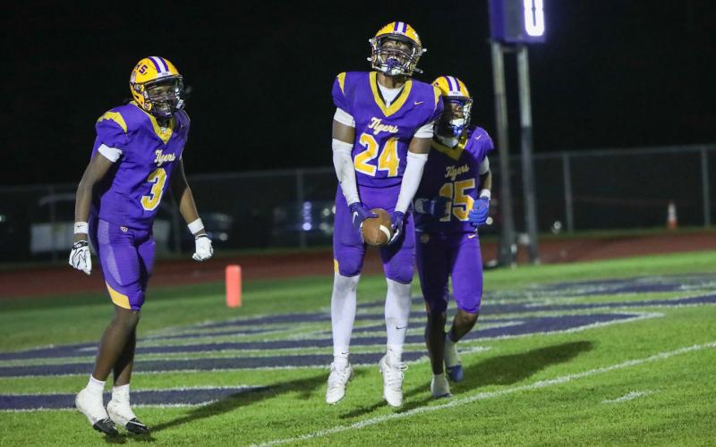Columbia defensive end Jae’quan Wilson (24) celebrates with defensive back Montenrrence Williamson (3) and defensive back Chris Austin (15) after recovering a fumble for a touchdown against Madison County on Friday. (BRENT KUYKENDALL/Lake City Reporter)