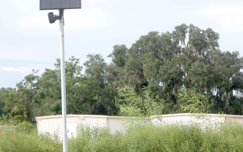 A Flock Safety camera sits along U.S. Highway 90 on the east side of Live Oak on Tuesday. (JAMIE WACHTER/Lake City Reporter)