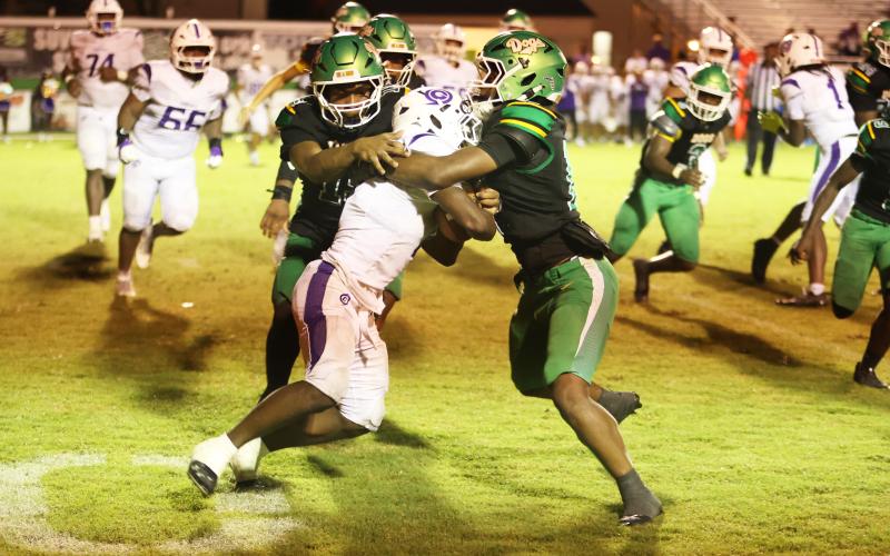 Suwannee safety Josh Johnson (right) and linebacker Marco Rojas wrap up Gainesville running back Javaris Gardner for a loss Friday night. (PAUL BUCHANAN/Lake City Reporter)