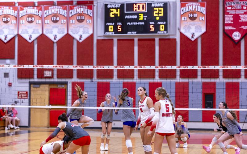 Columbia middle hitter Meleane Wood (3) and her teammates celebrate her block of Lafayette's Sophia Kendrick (9) to earn match point in a sweep of Lafayette on Thursday. (JACK HOWDESHELL/Lake City Reporter)