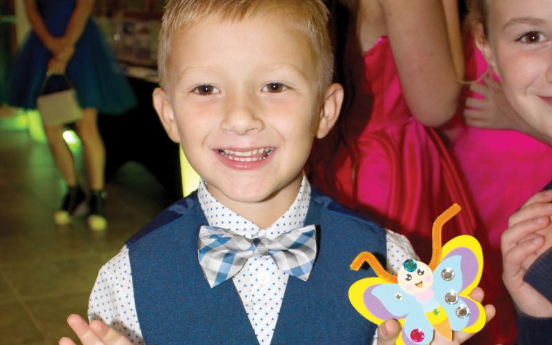 A child shows off a butterfly at last year’s inaugural Laced Up for Love Sneaker Ball. The Catholic Charities fundraiser returns later this month with a sneaker drive added. (COURTESY)