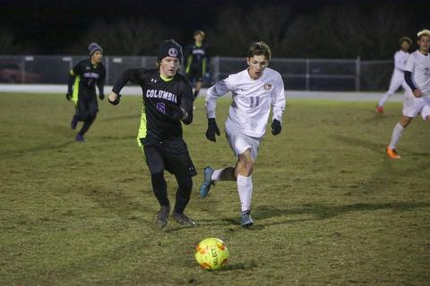 Columbia’s TJ Hudson races with Santa Fe’s Colton Weiser for possession of the ball on Thursday night. (BRENT KUYKENDALL/Lake City Reporter)