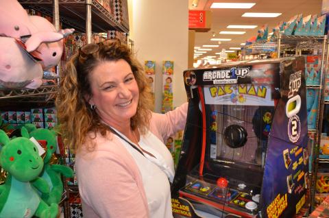 Bernadette Feickert eyes a miniature Pac-Man arcade machine at Belk on Friday morning. She wanted to get it for her 16-year-old, but imagined her two older sons would sneak turns on it, too. (CARL MCKINNEY/Lake City Reporter)