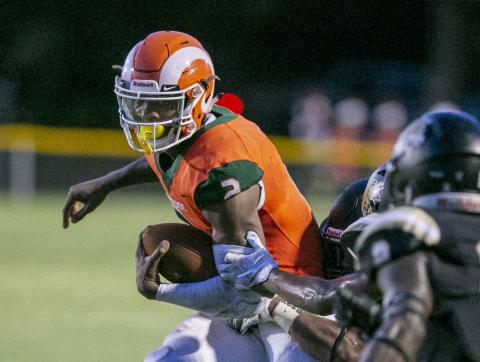 Eastside High quarterback Anthony Richardson evades a Buchholz defender during their game earlier this season at Citizens Field. (ALAN YOUNGBLOOD/TNS)