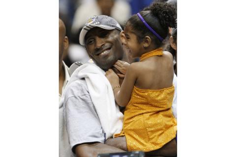 Los Angeles Lakers' Kobe Bryant holds his daughter, Gianna, after defeating the Orlando Magic 99-86 in Game 5 to win the NBA Finals on June 14, 2009 in Orlando. Bryant, the 18-time NBA All-Star who won five championships and became one of the greatest basketball players of his generation during a 20-year career with the Los Angeles Lakers, died in a helicopter crash Sunday. Gianna also died in the crash. (AP FILE PHOTO)