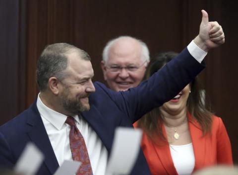 Sen. Rob Bradley, the Fleming Island Republican who represents Columbia County in the Legislature, gives a thumbs up as he leads the Senate committee to the House for the start of a joint session on Tuesday. (STEVE CANNON/Associated Press)