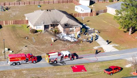 First responders are pictured at the scene shortly after a single-engine plane crashed into a Lake City home Saturday morning. (Ray Carpenter Photography)