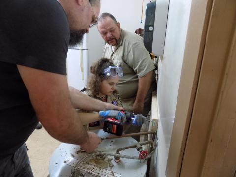 Jayson Wolff helps Skylar Beichner guide in a screw for a shelf as Tom Mullers, the scout master for Troop 85, the boys’ troop, looks on. Under rules put into effect last year, girls can form their own troops in the Boy Scouts, now known as BSA. (STEPHANIE CHAMBERS-WOLFF/Special to the Reporter)