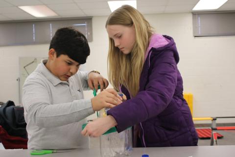 Juan Bustamante (left) and Azlynne Williams prepare for the presentation portion of a robotics competition. TONY BRITT/Lake City Reporter 