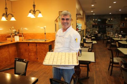 Abraham Farajian with a tray of baklava. (MICHAEL PHILIPS/Lake City Reporter)