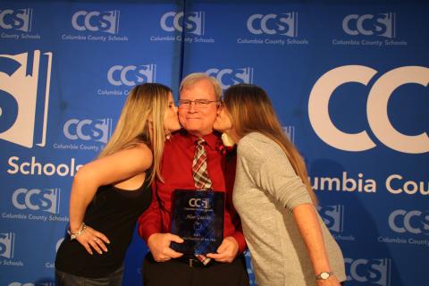 Megan Gatzke (left), gives her father, Alan Gatzke, a kiss on the check at the same time as her mother, Mary Gatzke. (TONY BRITT/Lake City Reporter)
