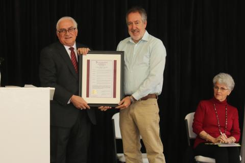 Mayor Stephen Witt presents Kevin Cheek with a copy of the proclamation honoring him on Arbor Day for his efforts beautifying Columbia County. (MICHAEL PHILIPS/Lake City Reporter)
