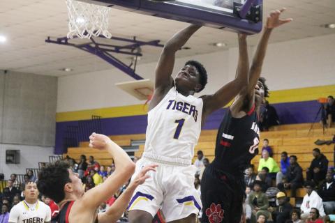 Columbia forward Marcus Peterson flies to the basket for a layup against Baker County on Friday night. (JORDAN KROEGER/Lake City Reporter)