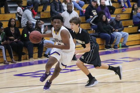 Columbia point guard Darrien Jones drives by Buchholz on Tuesday night. (JORDAN KROEGER/Lake City Reporter)