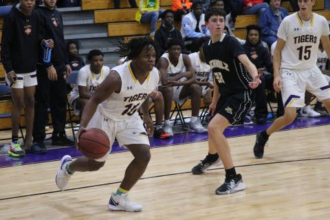 Columbia forward Marlon Pollock drives baseline against Buchholz on Jan. 21. (JORDAN KROEGER/Lake City Reporter)