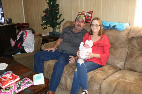 Mike Fortune sits next to his partner Cindy Adams, who holds their newborn baby, Ariella. Adams gave birth to Ariella on the side of the road in Alachua County last month. (TONY BRITT/Lake City Reporter)