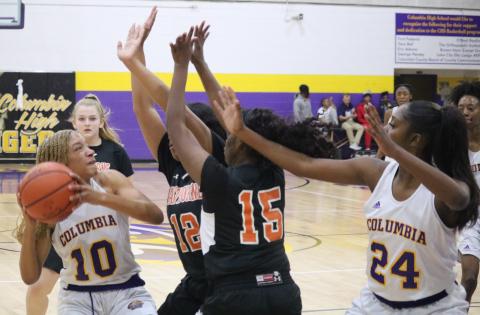 Columbia guard Taylor Ivery is swarmed by Hawthorne defenders during Thursday night’s game. (ZACH ABOLVERDI/Lake City Reporter)