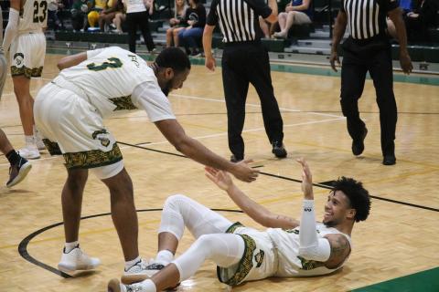 FGC guard Kenny Brown celebrates with Diamond Smith after Smith’s dunk against Trinity Baptist College on Thursday night. (JORDAN KROEGER/Lake City Reporter)