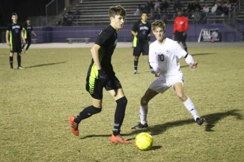 Columbia’s Max Bavar dribbles past Chiles’ Robbie Allman on Tuesday night. (JORDAN KROEGER/Lake City Reporter)