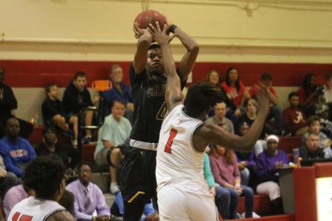 Columbia guard Kenney Gaines pulls up for a jumper over Santa Fe’s Jamir Harris on Friday night in Alachua. (ZACH ABOLVERDI/Lake City Reporter)