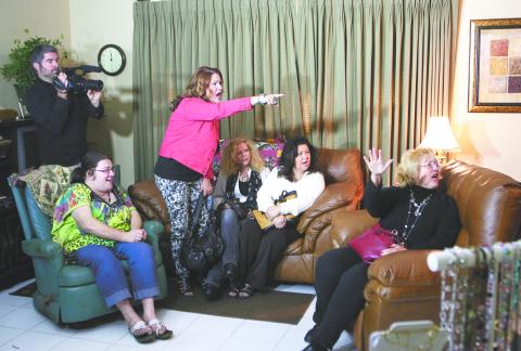 Jacquie Hagler (pointing) tells a would-be armed robber to “Get out in the name of Jesus” in this reenactment staged weeks later by The 700 Club for television. (FILE)