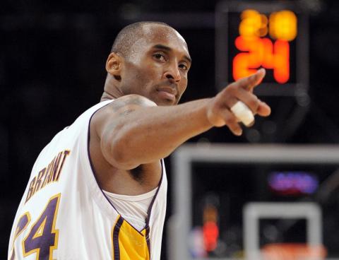 Los Angeles Lakers guard Kobe Bryant (24) points to a player behind him after making a basket in the closing seconds against the Orlando Magic in Game 2 of the NBA basketball finals on June 7, 2009, in Los Angeles. Bryant, the 18-time NBA All-Star who won five championships and became one of the greatest basketball players of his generation during a 20-year career with the Los Angeles Lakers, died in a helicopter crash Sunday. (AP FILE PHOTO)