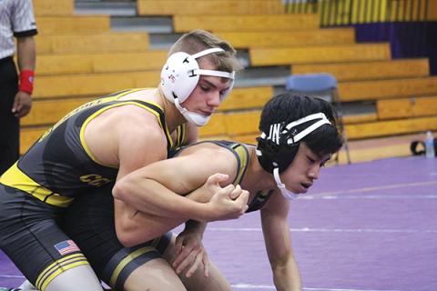 Columbia’s Alex McGuigan (left) wrestles in last year’s Tiger Duals. (FILE)