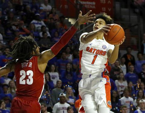 Florida guard Trey Mann goes for a shot around Alabama’s John Petty Jr. (23) during Saturday’s games at the O’Connell Center. [TRIBUNE NEWS SERVICE)