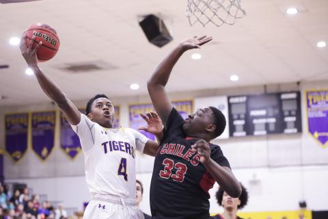 Columbia guard Kenney Gaines gets past Chiles forward Burl Gaskins for a layup during Thursday's Region 1-6A quarterfinal. (BRENT KUYKENDALL/Lake City Reporter)