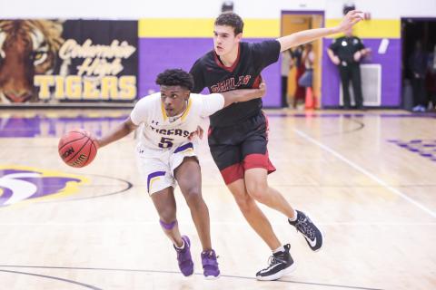 Columbia guard Darrien Jones drives by Chiles froward Sam Hartmann during Thursday's Region 1-6A quarterfinal. (BRENT KUYKENDALL/Lake City Reporter)