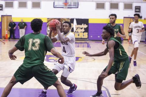 Columbia guard Kenney Gaines looks to pass as Lincoln’s defenses closes in during Tuesday’s Region 1-6A semifinal. (BRENT KUYKENDALL/Lake City Reporter)