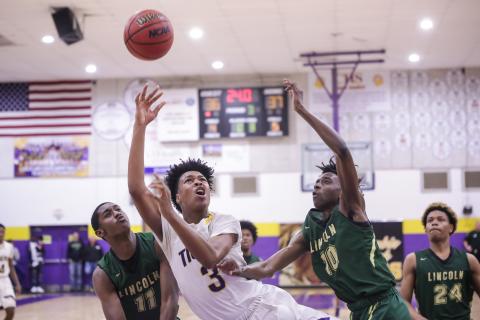 Columbia forward Charleston Ponds puts up a shot between Lincoln's Perry Fisher (11) and Jordan Wilford (10) during Tuesday night's Region 1-6A semifinal. (BRENT KUYKENDALL/Lake City Reporter)