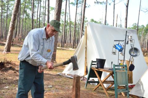 Mark Akers chops firewood at camp. Akers, an artillery coordinator for the Battle of Olustee re-enactment, has been camping at the battlegrounds for several days while he helps to organize one of North Florida’s biggest events. (CARL MCKINNEY/Lake City Reporter)