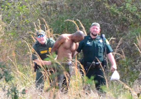 Suspect Breon Walker, 29, is led to a waiting cruiser after being apprehended by deputies. (CARL MCKINNEY/Lake City Reporter)