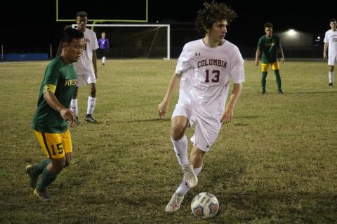 Columbia’s Tanner Pierce dribbles the ball away from Forest’s Marlon Rodriguez during Monday’s District 2-6A quarterfinals. (ZACH ABOLVERDI/Lake City Reporter)