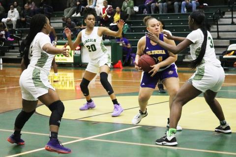 Columbia center Amaiya Callym is surrounded by Lincoln defenders during Saturday night's District 2-6A championship game. (JORDAN KROEGER/Lake City Reporter)