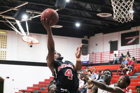 Fort White guard D.J. Mathews goes up for a shot against Hilliard during Tuesday’s District 6-1A semifinals. (ZACH ABOLVERDI/Lake City Reporter)
