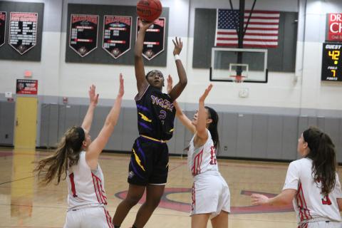 Columbia guard Na’Haviya Paxton shoots over Creekside’s defense during Thursday’s Region 1-6A quarterfinal. The Lady Knights won 65-50. (ZACH ABOLVERDI/Lake City Reporter)